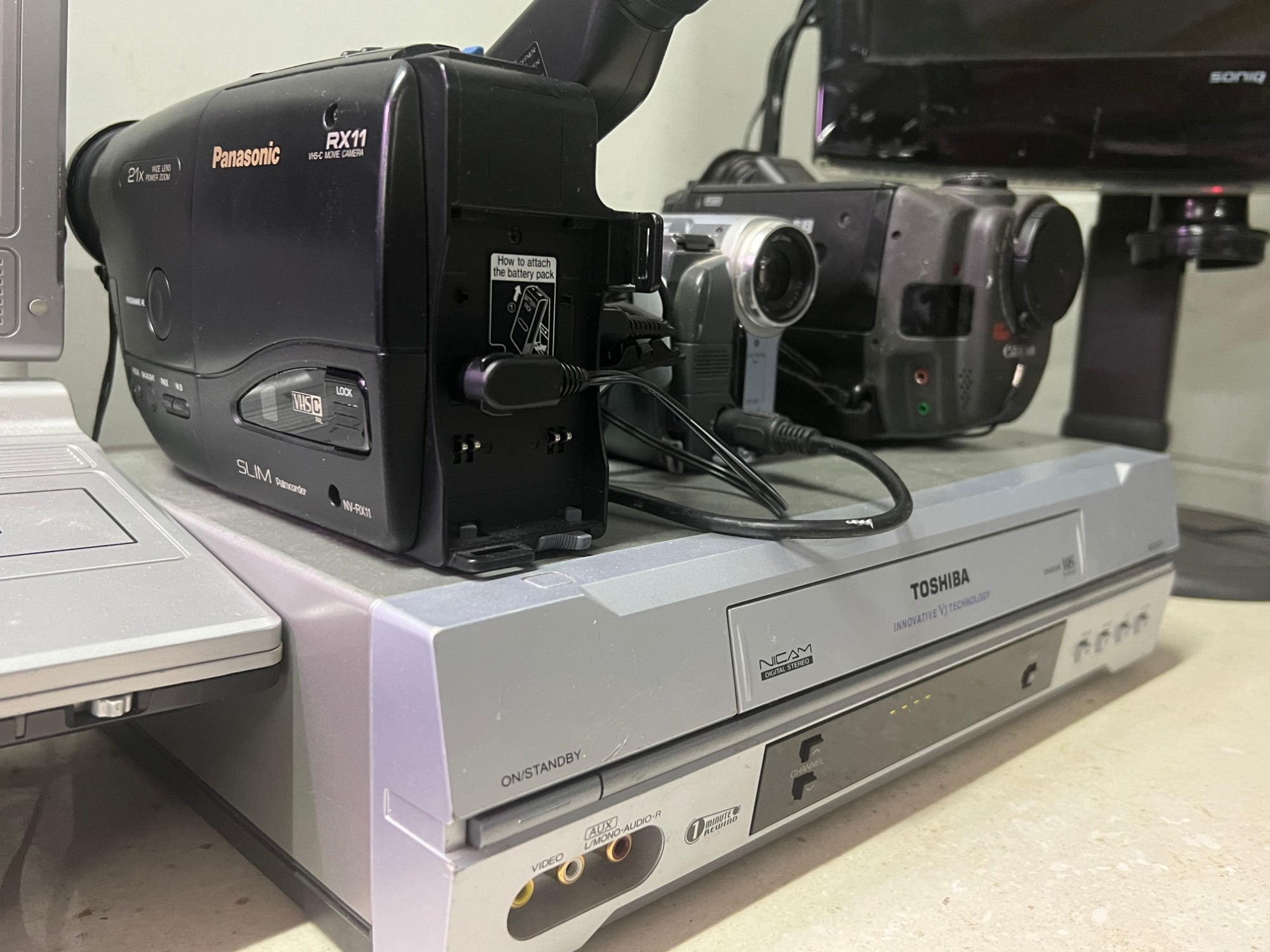 Vintage camcorders and a VHS player ready for transfer