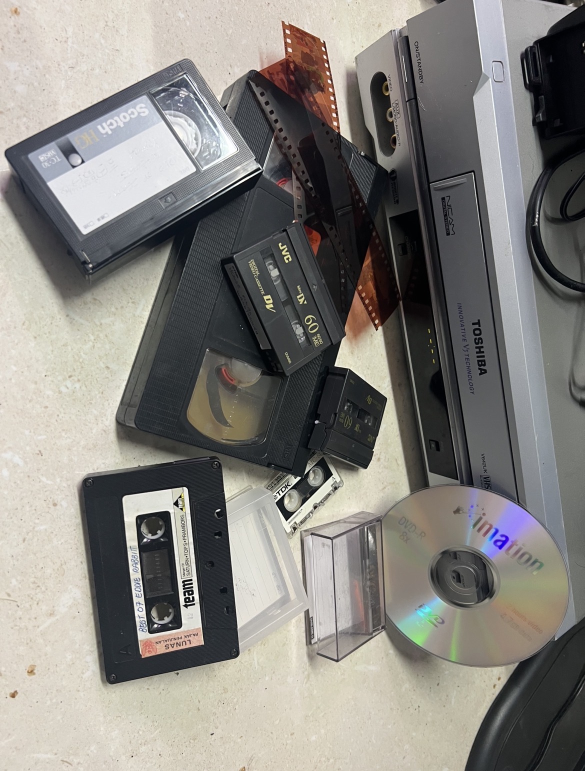A family collection of VHS tapes, MiniDV, film negatives, cassettes and DVDs